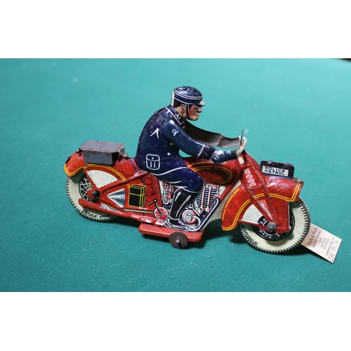 637 - A scarce Mettoy tinplate clockwork 'POLICE PATROL' motorcycle. Bike in red with yellow line and engi... 