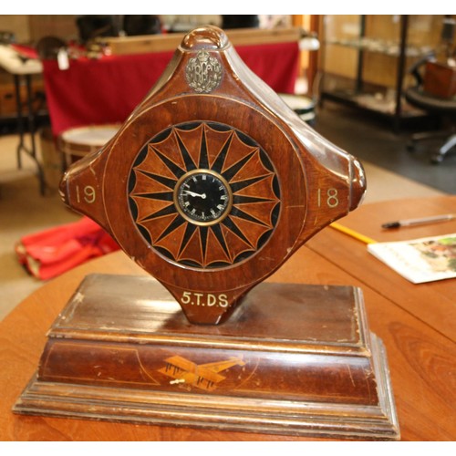 23 - A mantle clock set in a mahogany propeller boss, marked 