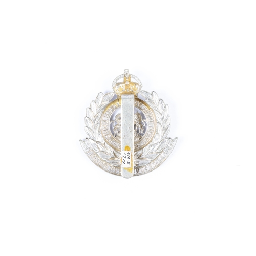 285 - A good scarce white metal cap badge of the Hong Kong Volunteer Corps. VGC, with old collection label... 