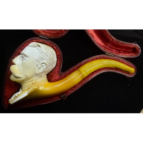 31 - An early 20th century meerschaum pipe, the bowl in the form of Lord Kitchener's head, in its red vel... 