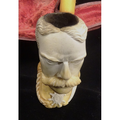 31 - An early 20th century meerschaum pipe, the bowl in the form of Lord Kitchener's head, in its red vel... 