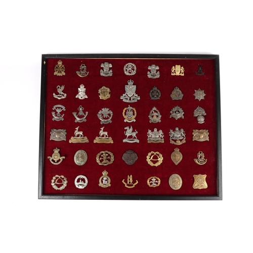 200 - 42 cap badges mounted in a frame, including Singapore Volunteer Corps, the rest mostly restrikes; al... 