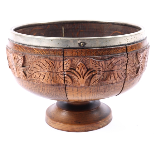 29 - A presentation carved oak footed bowl, 9½