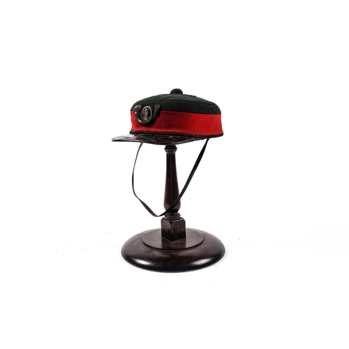 291 - A scarce Victorian Officer's peaked drill cap to the Tower Hamlets Rifles, c 1875, green with red ba... 