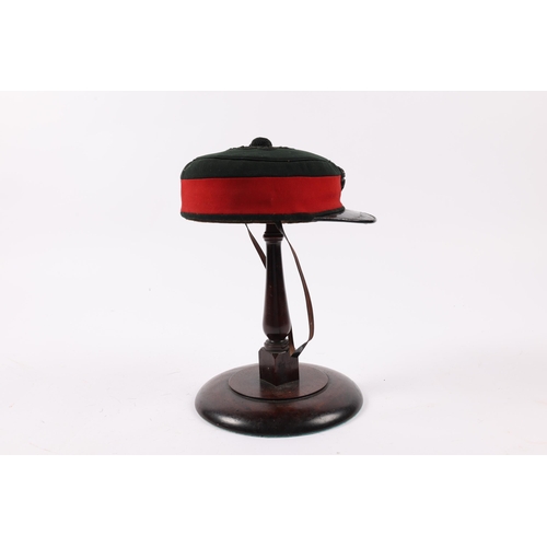 291 - A scarce Victorian Officer's peaked drill cap to the Tower Hamlets Rifles, c 1875, green with red ba... 