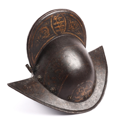 416 - A good German comb morion c 1600, formed in two halves, with brass rosettes around the base and bras... 