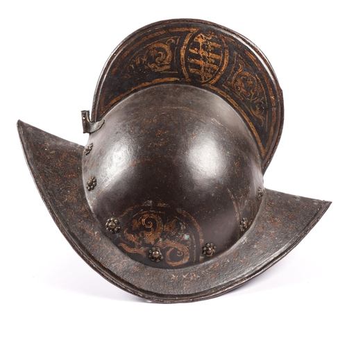 416 - A good German comb morion c 1600, formed in two halves, with brass rosettes around the base and bras... 