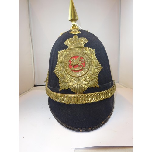 300 - A Victorian OR's home service helmet to the East Kent Regiment, Buffs, blue cloth with brass mounts.... 