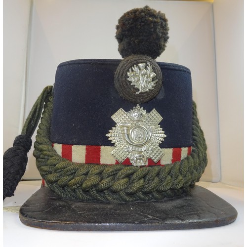 261 - An OR's shako of the Highland Light Infantry, with wool plume and patent leather chinstrap, the lini... 