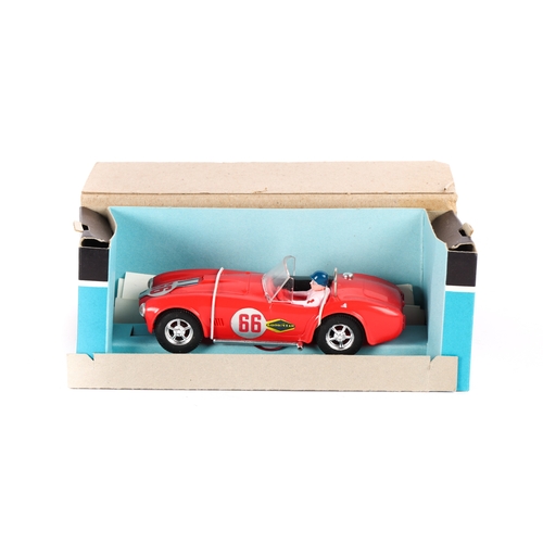 227 - A Scalextric A.C. Cobra in red with driver and 5 spoke chrome wheels. Contained in its original brow... 