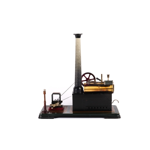 275 - A Bing horizontal single cylinder (overtype) stationary steam engine. Mounted on a dark green and br... 