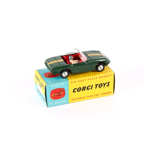 332 - Corgi Toys Lotus Elan (318). An example in dark green with yellow stripe and red interior, complete ... 