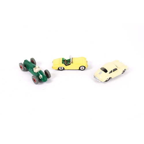 388 - 3 scarce Dinky Toys. A Triumph TR2 (105) in lemon yellow with pale green interior, grey driver, spun... 