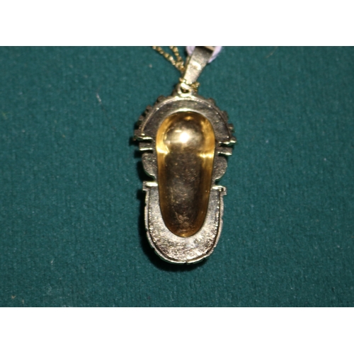 39 - A 18K gold hallmarked chain, with a Tribal looking head pendant, also stamped 18K, very well cast. p... 