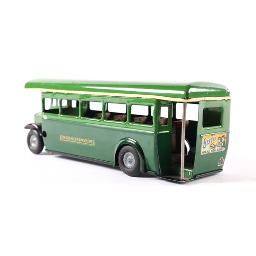 435 - A late issue Tri-ang Minic clockwork powered single deck bus 52M. In two tone green London Transport... 