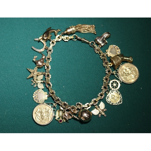 45 - A Very impressive 9ct gold hallmarked  charm bracelet with 16 charms, includes 2 shell charms with s... 