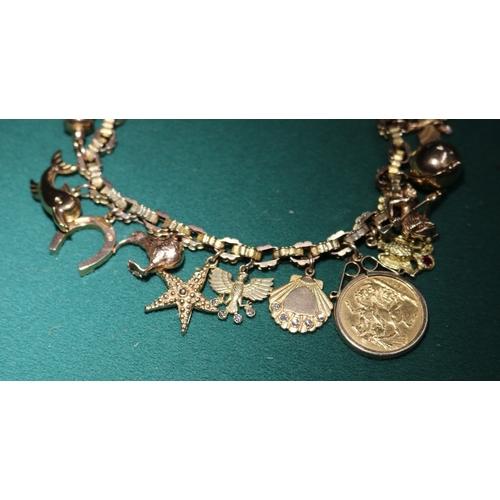 45 - A Very impressive 9ct gold hallmarked  charm bracelet with 16 charms, includes 2 shell charms with s... 