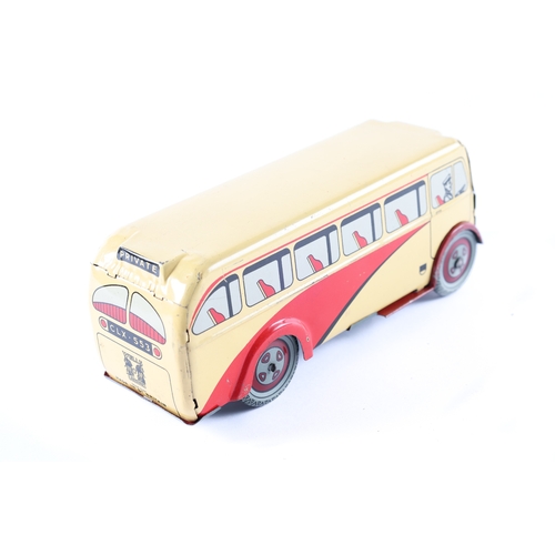 450 - A scarce WELLS  clockwork single deck coach, finished in cream and red. Stamped to the rear with the... 