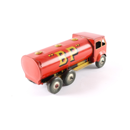 457 - A large Mettoy clockwork tinplate AEC style 3 axle 6 wheel Petrol Tanker. 26cm. In red and yellow SH... 