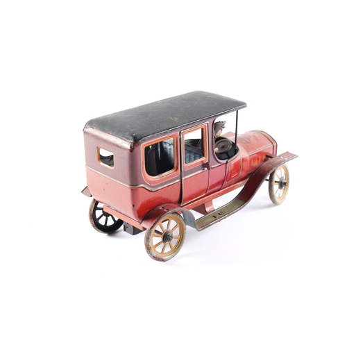 468 - A rare 1920's Bing clockwork tinplate Limousine. 20.5cm overall length, finished in red (faded on on... 