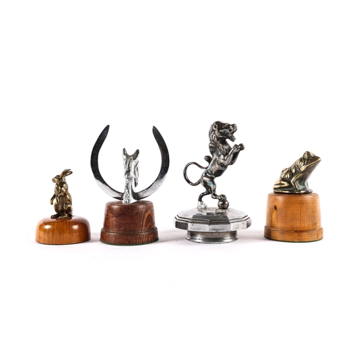 7 - 4 vintage car mascots. A plated horses head and shoe. A brass sitting frog. A brass standing Hare an... 