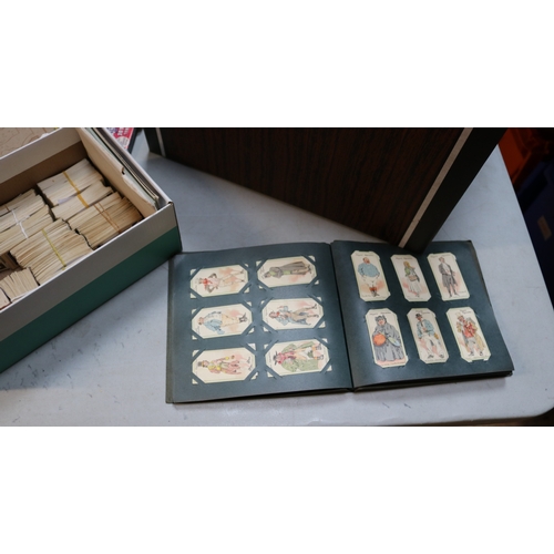 13 - A large collection of cigarette and tea cards, contained in albums, old cigarette packets and loose.... 