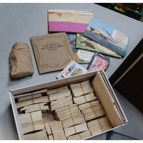 13 - A large collection of cigarette and tea cards, contained in albums, old cigarette packets and loose.... 