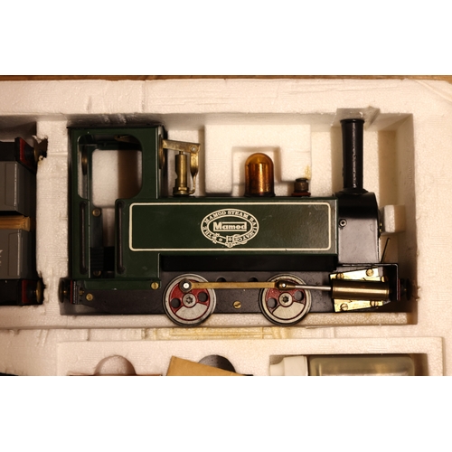 194 - 'The Mamod Steam Railway Co' Train set. Comprising of a live steam 0-4-0 tank locomotive painted in ... 