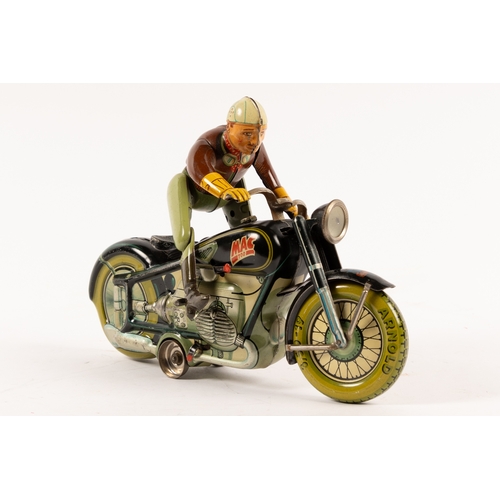 351 - An Arnold 'Mac700' tinplate clockwork Motor Cycle. In black with rider who dismounts and mounts the ... 