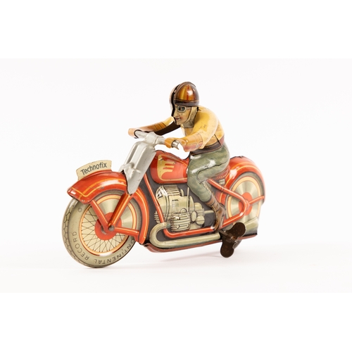 353 - A Technofix tinplate clockwork Motor Cycle. Registration No. GE258. In orange/red with cream highlig... 