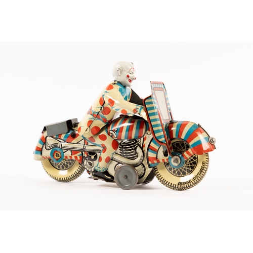 361 - A rare Mettoy tinplate clockwork Clown on Motorcycle. Finished in red, white and blue stripes, clown... 