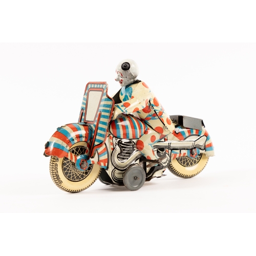 361 - A rare Mettoy tinplate clockwork Clown on Motorcycle. Finished in red, white and blue stripes, clown... 