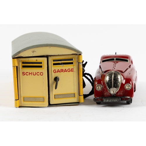 369 - Schuco Kommando Anno-2000 Car and Garage. The car is in maroon with opening bonnet, clockwork motor ... 