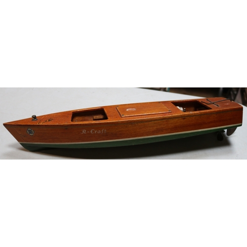 81 - A possibly Sutcliffe Wooden boat with R-CRAFT printed to each side. Has parts of the motor and some ... 