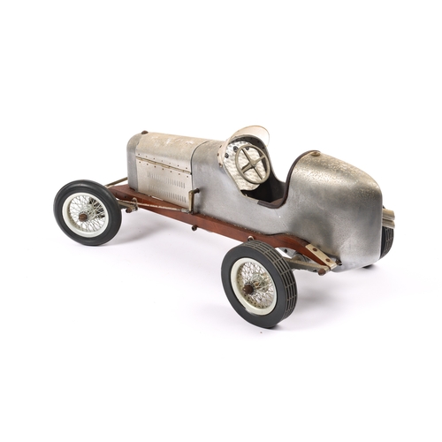 88 - A scarce aluminium body TETHER racing car with wooden chassis. Has large spoke wheels with rubber ty... 