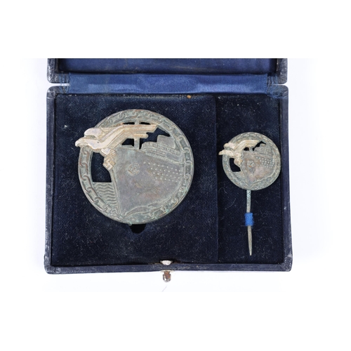 107 - A Third Reich Blockade Runner's badge and tie pin, in original case of issue. GC £200-250