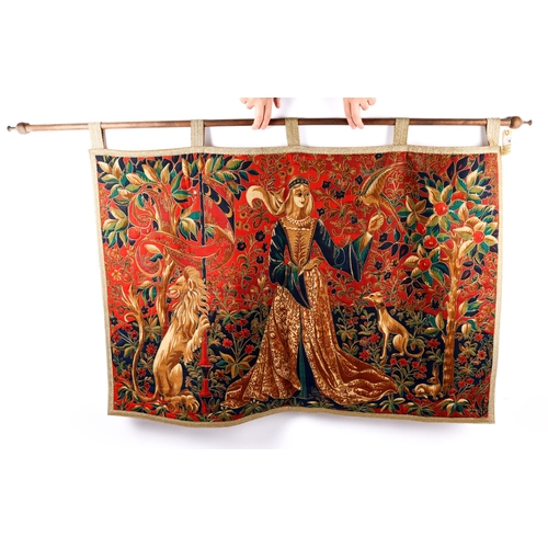 18 - A finely executed mediaeval style tapestry hanging, depicting a lady of rank flanked by a lion and a... 