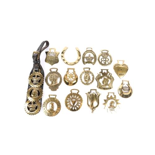 29 - A small collection of horse brasses: 3 for Queen Victoria's 1887 Jubilee mounted on a leather martin... 