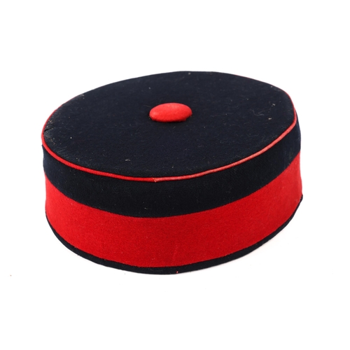 259 - A Victorian OR's blue pill box hat of the Volunteer Artillery, with red band and piping. GC (chinstr... 