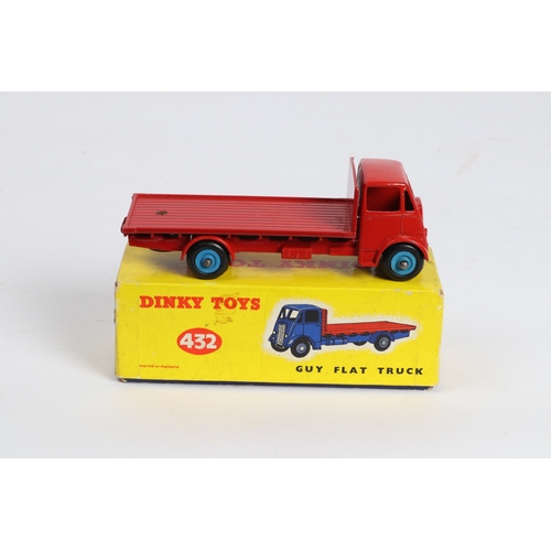 315 - A Dinky Toys Guy Flat Truck (432), Cab and chassis in red with red loadbed and mid blue wheels. Boxe... 