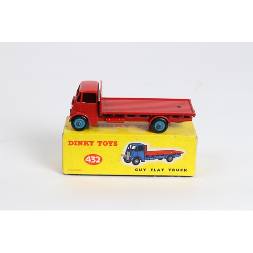 315 - A Dinky Toys Guy Flat Truck (432), Cab and chassis in red with red loadbed and mid blue wheels. Boxe... 