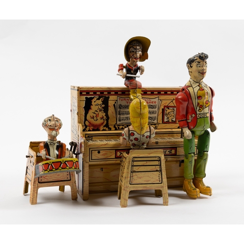 371 - A rare tinplate clockwork toy 'Lil Abner and his dog Patch Band'. Clockwork action makes the standin... 