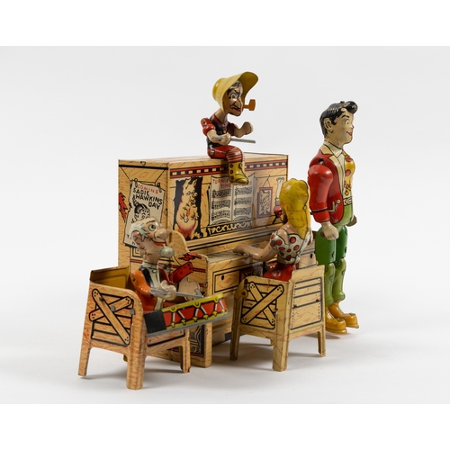 371 - A rare tinplate clockwork toy 'Lil Abner and his dog Patch Band'. Clockwork action makes the standin... 