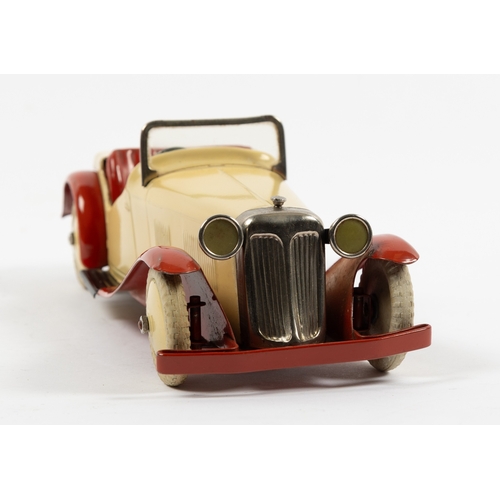 375 - A rare Meccano clockwork Non Constructor Car. A Two-Seater Sports Car in cream with red seats, mudgu... 