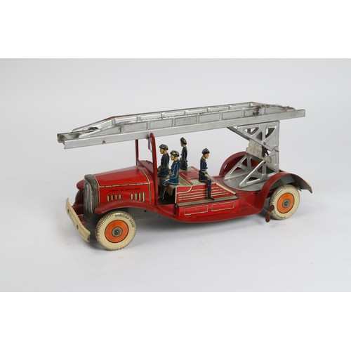 376 - A scarce Tinplate windup Fire Engine in red with extending  ladder and 4 firemen figures, Made in En... 