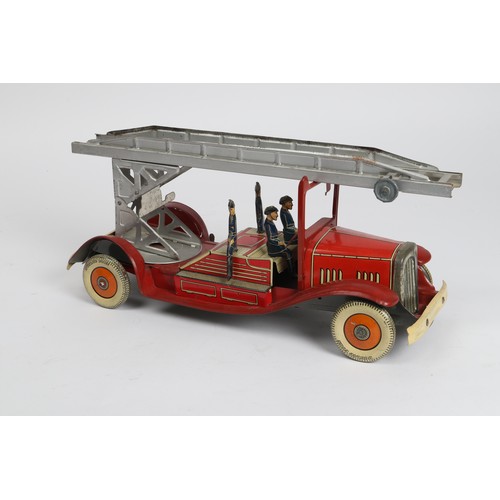 376 - A scarce Tinplate windup Fire Engine in red with extending  ladder and 4 firemen figures, Made in En... 