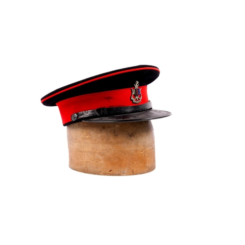 261 - A scarce officer's peaked SD cap of the Cinque Ports Regiment, blue cloth with red band and piping, ... 