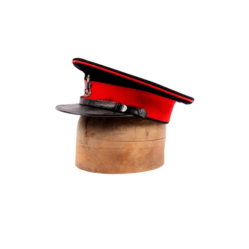 261 - A scarce officer's peaked SD cap of the Cinque Ports Regiment, blue cloth with red band and piping, ... 