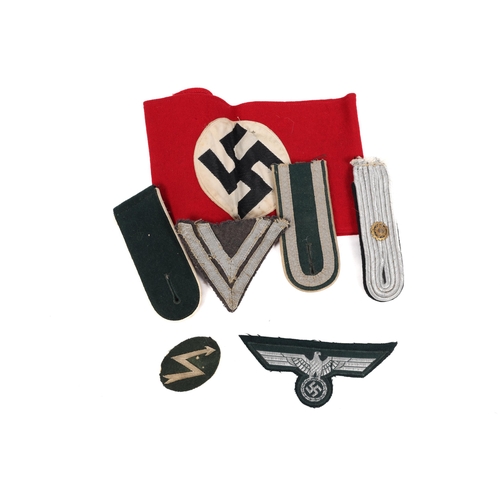 93 - A Third Reich NSDAP arm band, 3 shoulder boards, a bevo weave eagle and 2 other items. GC £40-50