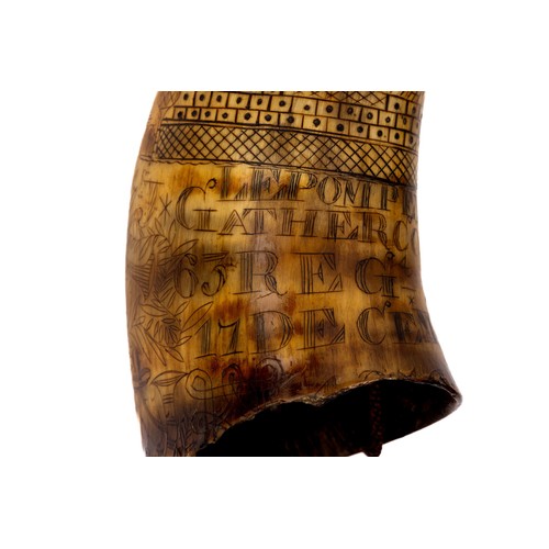 310 - A Georgian powder horn heavily decorated with scrimshaw carving, including 